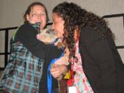 Edgewood Park: Harney parent Leslie Rowe, left, holds Petunia the piglet while third-grade Spanish immersion teacher Andrea Fuentes-Diaz puckers up.