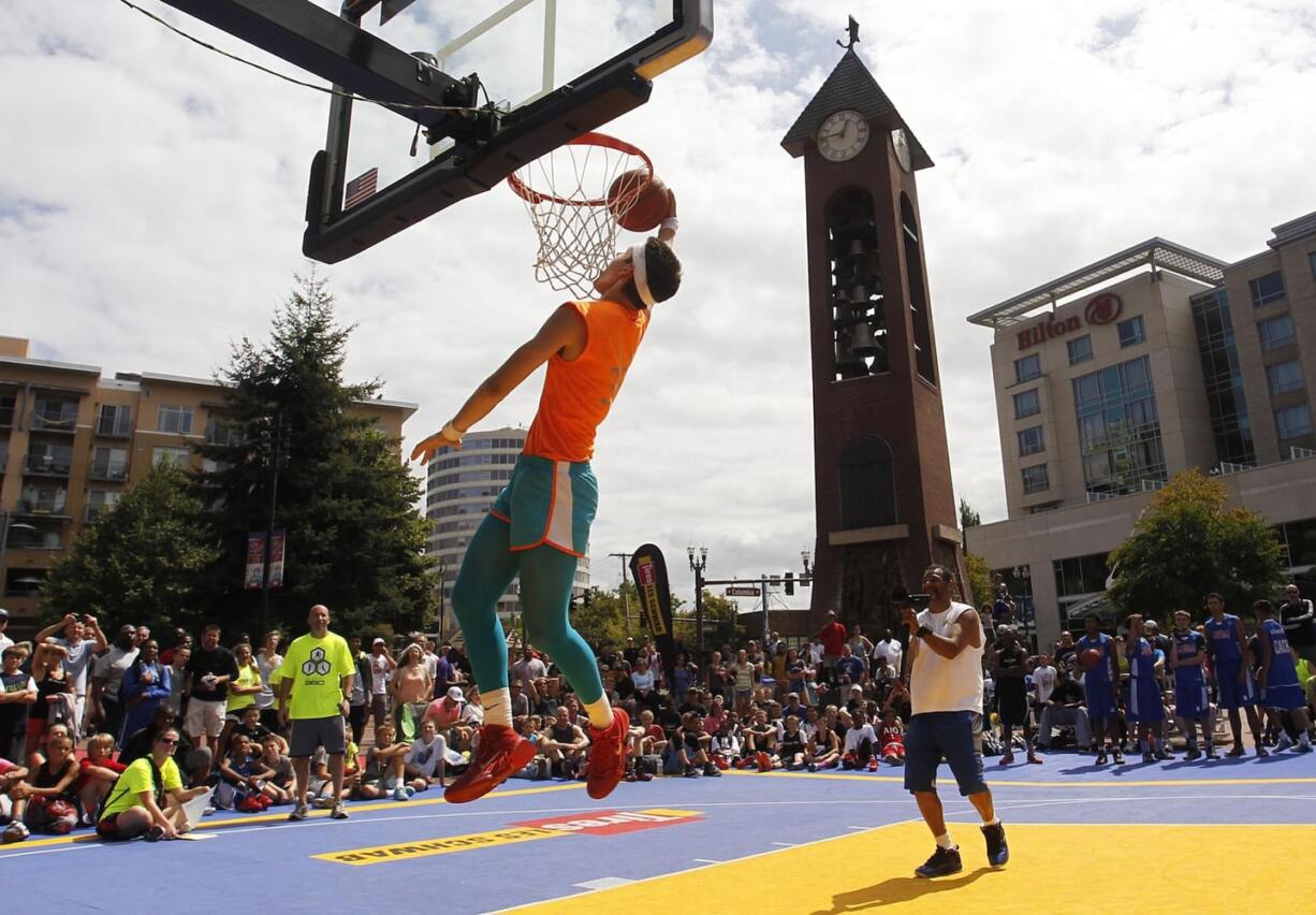 Tanner Fogle elevates in the slam dunk contest at Hoops on the River on Aug. 15 in Esther Short Park in downtown Vancouver.