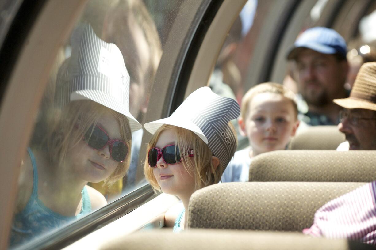 Tesla Dobson, 7, Kalama, whose family includes three generations of railroaders, peers out the window Monday during BNSF Railway's excursion for railroad families.