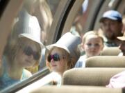 Tesla Dobson, 7, Kalama, whose family includes three generations of railroaders, peers out the window Monday during BNSF Railway's excursion for railroad families.