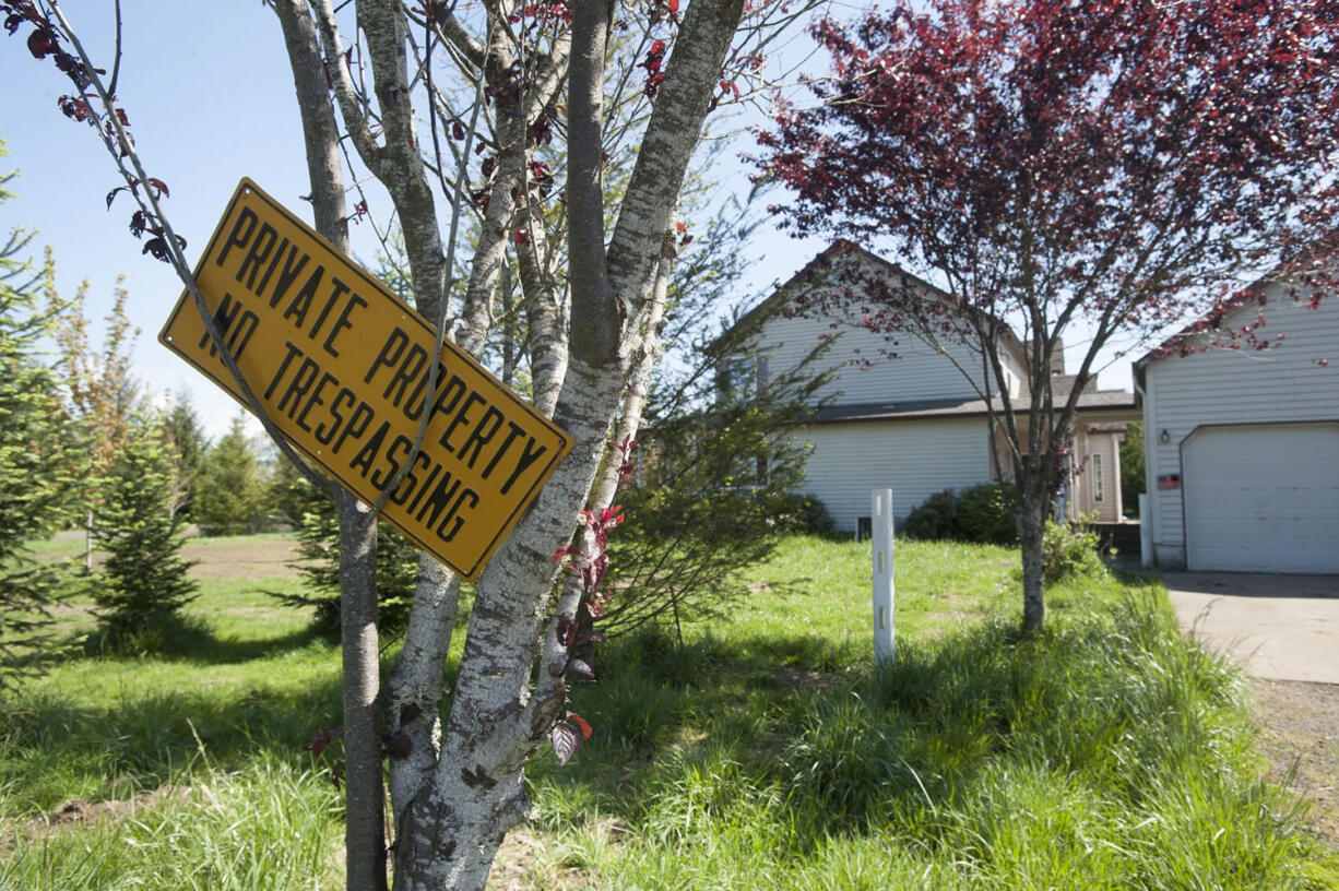 Police say squatters who live in a rural Washougal house took down and sold the white fencing that surrounded the house.