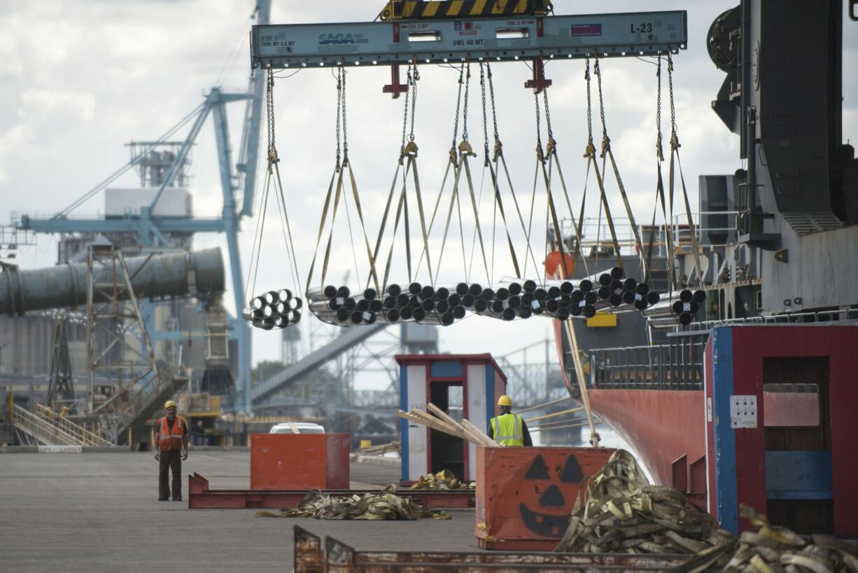 Slingmen and other port workers take in an arriving shipment of steel from the &quot;Saga Explorer&quot; a Hong Kong flagged container vessel at athe Port of Vancouver Wednesday April 29, 2015.