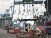 Slingmen and other port workers take in an arriving shipment of steel from the &quot;Saga Explorer&quot; a Hong Kong flagged container vessel at athe Port of Vancouver Wednesday April 29, 2015.