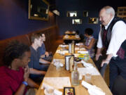 Longtime Lunch Buddy Steve Runyan greets Isaiah Ephraim, from left, Nathan Harris and Seth Hunt at Lapellah for a grown-up lunch Friday. Nine years ago Runyan began meeting with his three lunch buddies, who all attended low-income Martin Luther King Elementary.