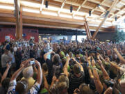 Hundreds of Seattle Seahawks fans snap pictures as the Vince Lombardi Trophy is revealed and placed on a pedestal during a 12 Tour event Friday at Big Al's in east Vancouver.