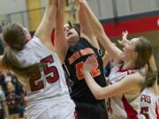 Camas defenders Nikki Corbett (25) and Emma Jones (21) block a potential game-tying shot by Battle Ground's Jossilyn Blackman (42) in the last seconds of Friday's game.