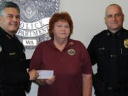 Bagley Downs: Vancouver Police Chief James McElvain, left, and Assistant Chief Mike Lester, right, accepting a $1,400 check from Karen McCallister and various neighborhood associations for the Neighbors on Watch program, which they donated in honor of her late husband, Edward &quot;Lee&quot; McCallister.