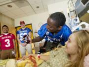 E'Lon Mack, from Heritage, shoots a selfie with Shriners patient Skyla deLint, 17, from Cove, OR, during a tour of the hospital, Wednesday, July 9, 2014.