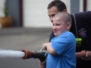 Washougal: Gaerett Bailey learned to use a fire hose from a local firefighter as part of Hathaway Elementary School's Young Men In Action program.