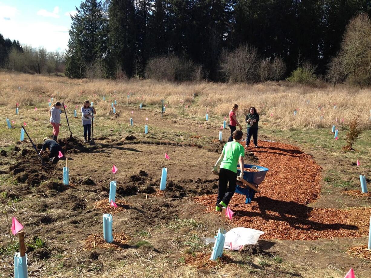 Battle Ground: Tukes Valley Middle School students building a nature trail through the green space adjacent to the campus, which helped earn Tukes Valley a Green School Certification.