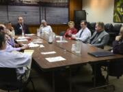 Six of seven candidates for Port of Vancouver commissioner fielded questions Monday from The Columbian's editorial board, who sit at the left of the table. Clockwise from the head of the table are: Eric LaBrant, Bob Durgan, Lisa Ross, Peter Harrison, Nick Ande and Bill Hughes.