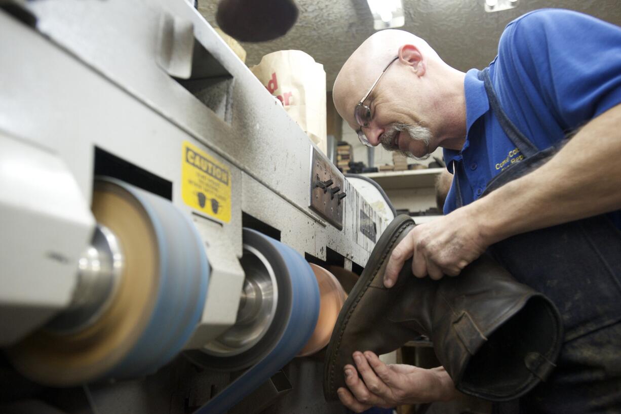 Photos by Steven Lane/The Columbian
Cobbler Ron Wells repairs a boot at Corner Cobbler Shoe Repair in Vancouver.