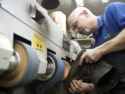 Photos by Steven Lane/The Columbian
Cobbler Ron Wells repairs a boot at Corner Cobbler Shoe Repair in Vancouver.