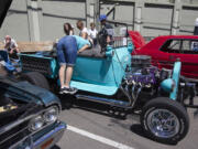 A woman check the seats of a vintage car at the 9th Annual Camas Car Show in downtown Camas, Saturday July 5, 2014.