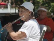 Flautist Phyllis Jeane Spears performs with the Vancouver Pops Orchestra during a free performance in Esther Short Park on Wednesday at noon. It was the beginning of the city's series of free lunchtime summer concerts, which run through Aug.