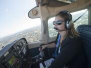 Pilot Theresa Nelson flies a Cessna 172 over Clark County on July 28. Nelson is the only woman out of 10 flight instructors at Aero Maintenance Flight Center at Pearson Field.