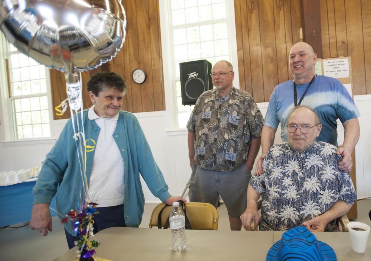 The outreach team at Memorial Lutheran Church holds a retirement tribute to Gary Schonberger, right, in mid-April. Schonberger has stepped down as the leader of the church's food ministry and daily soup kitchen.