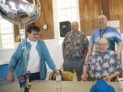 The outreach team at Memorial Lutheran Church holds a retirement tribute to Gary Schonberger, right, in mid-April. Schonberger has stepped down as the leader of the church's food ministry and daily soup kitchen.