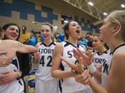 Larissa Hamilton, 24, center, and Katie Swanson, 42, left, celebrate Skyview's victory over Evergreen.