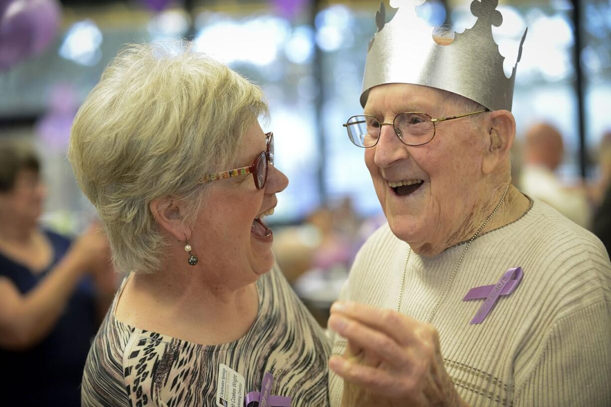 Photos by Ariane Kunze/The Columbian
Deb Coakes Wright, the marketing director at Clearwater Springs, dances with senior John Nelson at the Luepke Senior Center Thursday for the the annual &quot;Turn the Town Purple&quot; event. Civic leaders danced with senior citizens at the event in honor of World Elder Abuse Awareness Day.