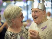 Photos by Ariane Kunze/The Columbian
Deb Coakes Wright, the marketing director at Clearwater Springs, dances with senior John Nelson at the Luepke Senior Center Thursday for the the annual &quot;Turn the Town Purple&quot; event. Civic leaders danced with senior citizens at the event in honor of World Elder Abuse Awareness Day.