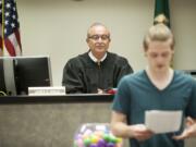 Clark County Superior Court Judge James Rulli listens to Beau Molyneux, 17, read an essay about how he benefited from a juvenile recovery program during a ceremony May 27, 2015, in Vancouver.