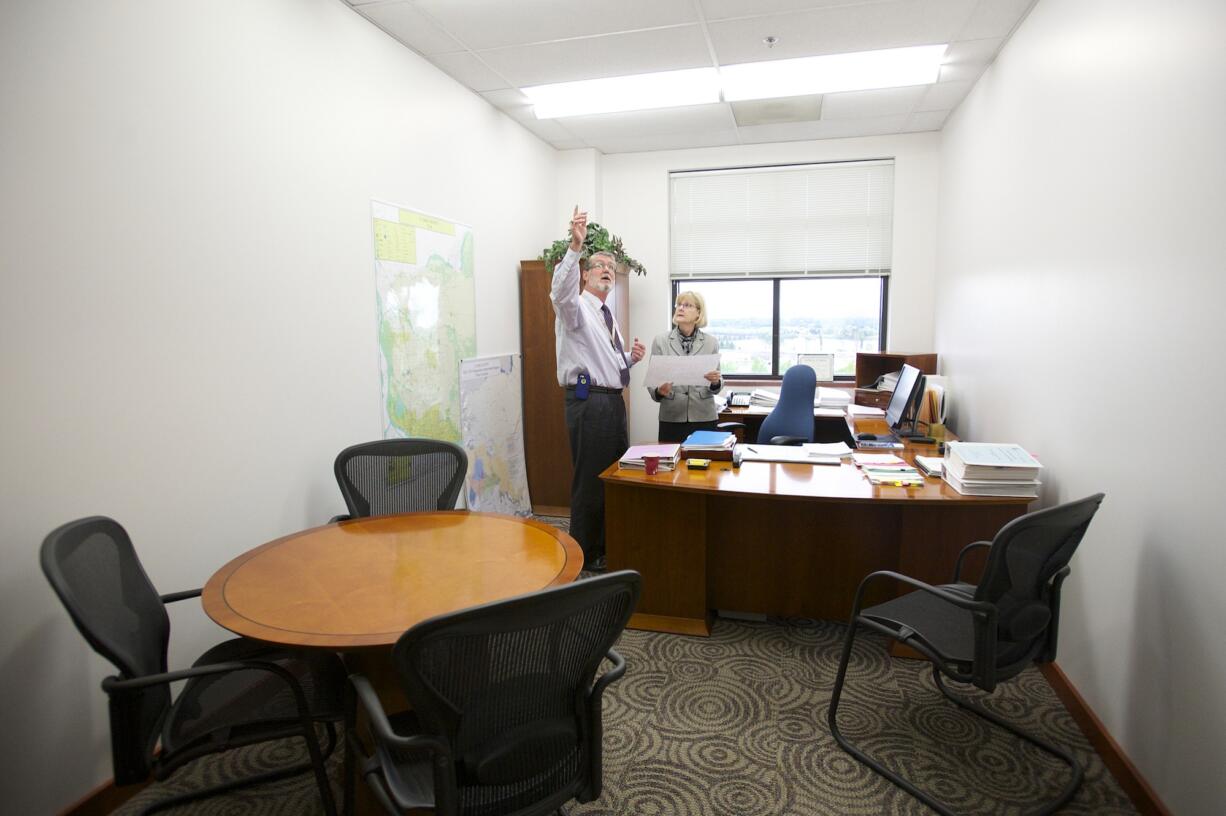 Acting County Manager Mark McCauley explains to Councilor Jeanne Stewart on Tuesday what it would take to convert an existing conference room into two new offices for the incoming county councilors.