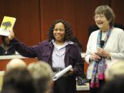 Cornetta Smith, left, shows off a new book Wednesday with author Jane Elder Wulff during a lunchtime presentation at the Clark County Public Service Center.