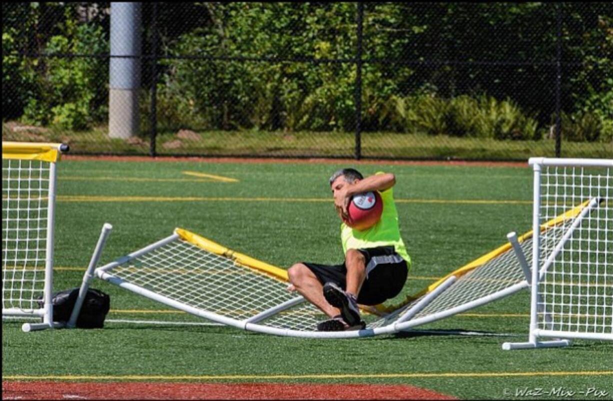 Northeast Hazel Dell: Keller Williams Realty agent Brian Combs makes a catch during a charity kickball match on July 26 to benefit the Dream Big Community Center.