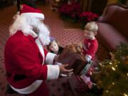 Kids meet with Santa at the Marshall House.