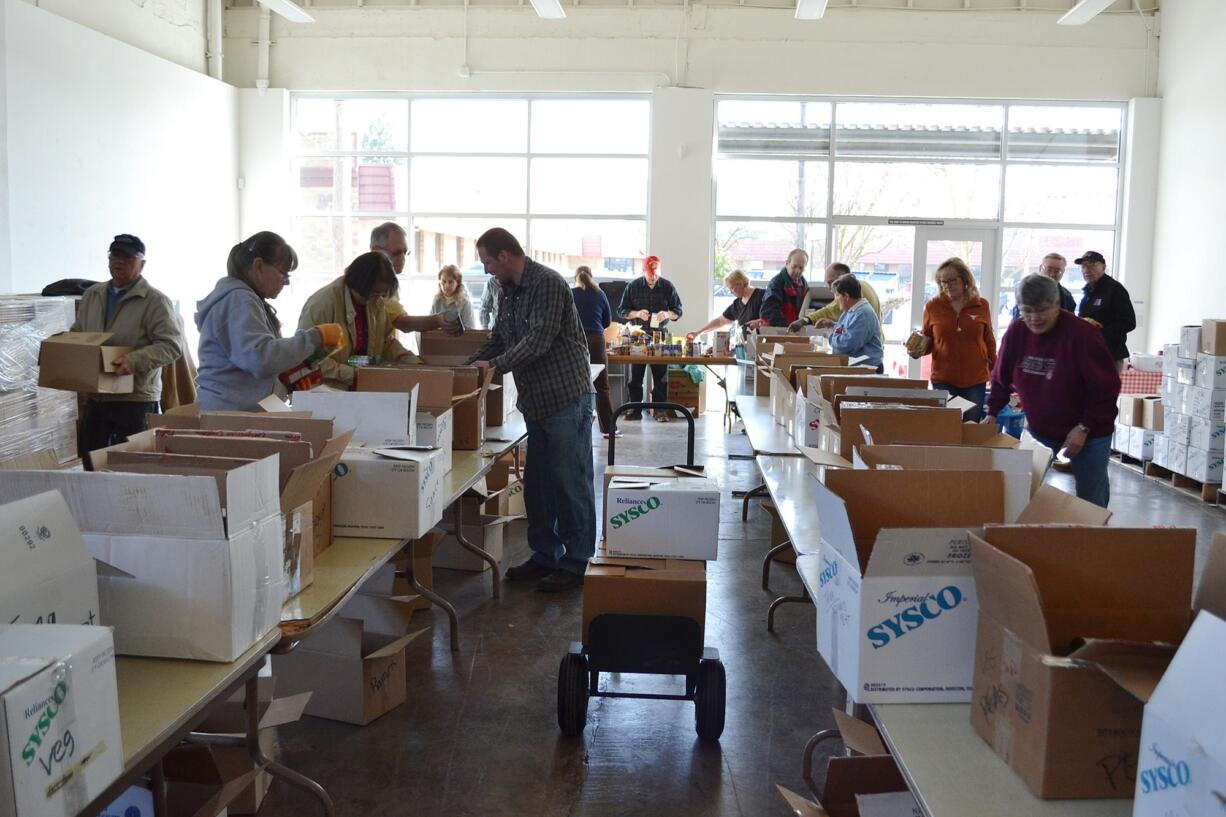 Esther Short: Volunteers sort through more than 26,000 pounds of food donated to FISH of Vancouver from the Walk