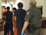 Acupuncturist Kooyeoll Jung is escorted out of Clark County Superior Court after making a first appearance today on suspicion of raping a client.