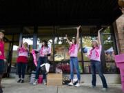 Shayna Hamilton, left, is cheered by members of the Camas High School girls basketball team after making a shot in to a pink recycling bin during the Downtown Camas Association's Girls' Night Out on Sept. 25.