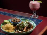 Zachary Kaufman/The Columbian
Lamb marinated in a special sauce is served with rice, whole beans and tortillas at Los Dos Compadres in Washougal.