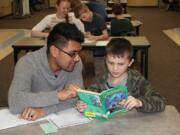 Battle Ground: Elementary education students from Washington State University Vancouver have been helping Milo Levanen, right, and other third-grade students at Captain Strong Primary School with their reading this semester.