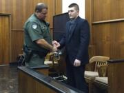 Jarrod Wiebe, 27, of Snohomish is escorted out of Clark County Superior Court Judge Scott Collier's courtroom after a jury found him guilty of 16 felony charges related to a home-invasion robbery in Ridgefield in December.