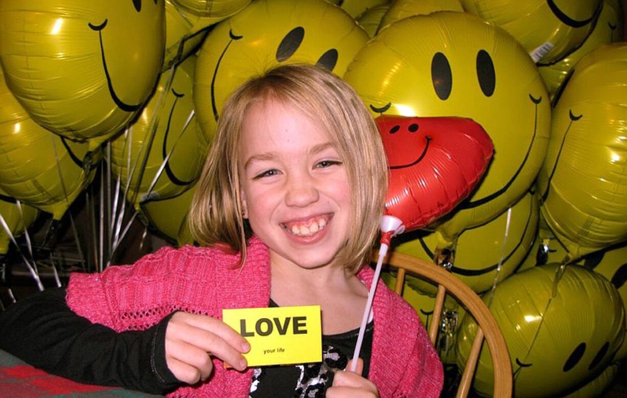 Salmon Creek: Taryn Larsen, 8, signed cards for each balloon given to patients spending Christmas at Legacy Salmon Creek Medical Center.