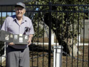 Willard Carroll, 87, of Vancouver holds a photo of the old apple tree that his mom, Esther Mason took in 1923.