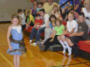 Washougal: A large snake makes friends with Magdelana Long during a July 14 visit by &quot;Reptile Man&quot; Scott Petersen to Hathaway Elementary School.