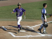 Pearl City's Rayson Carriaga, left, strides past Manhattan Beach catcher Jake Gordon to score in the first inning Wednesday evening, August 12, 2015 at Propstra Stadium.