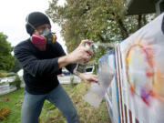 Allen Russell says he hardly ever picked up a paintbrush before taking a notion this summer to start spraying murals on the walls and fence around his yard.