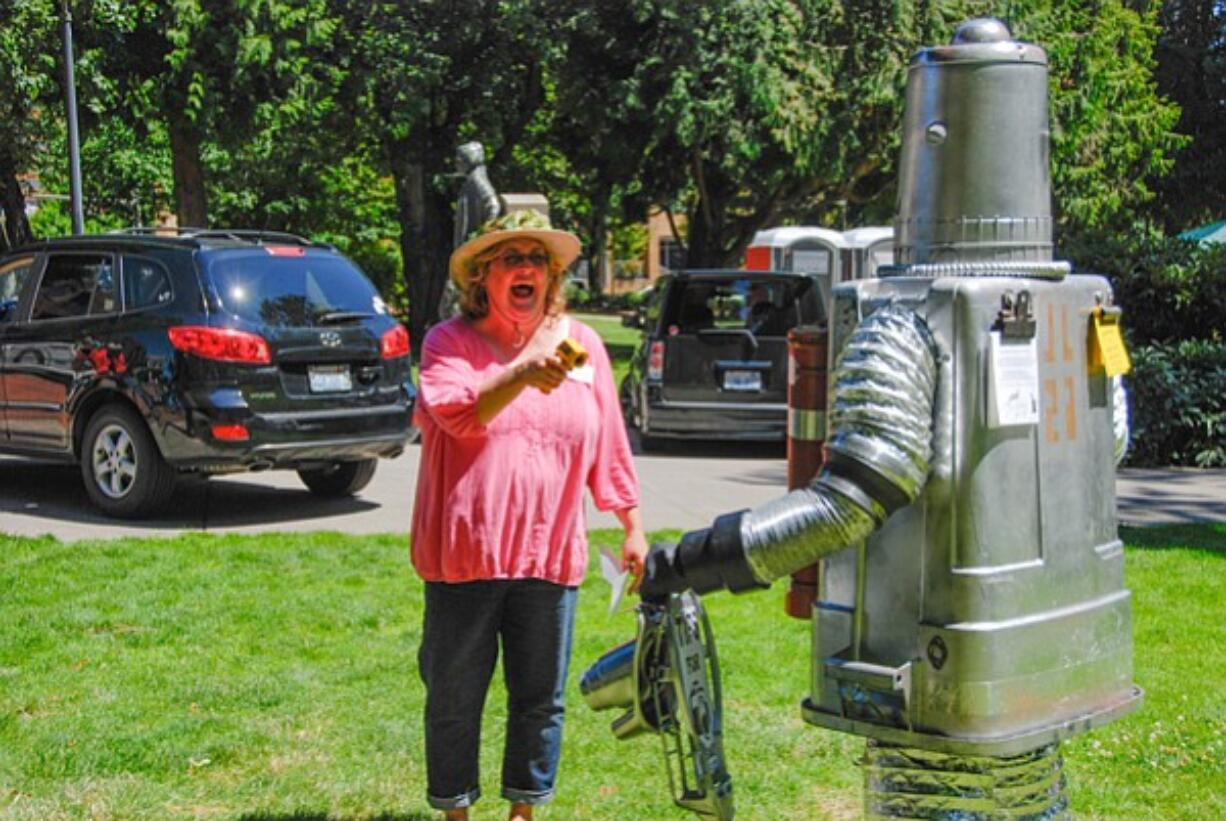 Laura Heldreth isn't mugging this Tin Man, she's only taking his temperature with a laser thermometer. His silvery body and dryer-duct limbs &quot;reflected the heat pretty well,&quot; said organizer Erika Johnson.