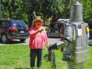 Laura Heldreth isn't mugging this Tin Man, she's only taking his temperature with a laser thermometer. His silvery body and dryer-duct limbs &quot;reflected the heat pretty well,&quot; said organizer Erika Johnson.