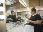 Meghan Hamilton, co-owner of GLAMbeauty Bar  prepares her makeup brushes before the grand opening of her shop in the renovated Sparks building on Evergreen Boulevard between C Street and Broadway in downtown Vancouver.