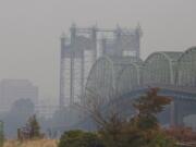 A pall of smoke blankets the Interstate 5 Bridge and downtown Vancouver on Saturday afternoon after a wind shift brought smoke and ash from Washington wildfires into the area.