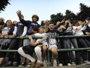 Skyview High School students, Damarcus Ball, 17, with Trey shirt on, Matt Fleischauer, 17, white sox, and Brad Usselman, 17, cheer for the home team with classmates before the start of the Skyview Sherwood High School game at Kiggins Bowl Friday in Vancouver.