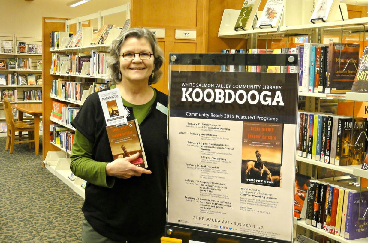 White Salmon Valley Community Library librarian Jennifer Hull holds &quot;Short Nights of the Shadow Catcher,&quot; chosen for the library's first Koobdooga: Community Reads program.