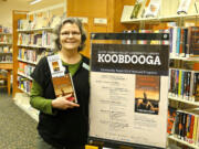 White Salmon Valley Community Library librarian Jennifer Hull holds &quot;Short Nights of the Shadow Catcher,&quot; chosen for the library's first Koobdooga: Community Reads program.