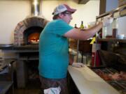 Jeremy Brown, owner of Rusty Grape Vineyard, prepares food for a wine tasting on July 26, 2013.