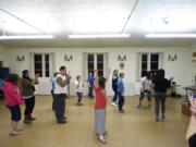 Students cheer after learning parts of a new dance routine during a hip-hop dance class geared toward people with developmental disabilities.